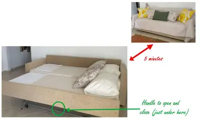 a bed in a room with a couch and a green arrow at Dans une villa avec piscine privée, calme, proche des plages, vues mer et montagnes in Tsivarás