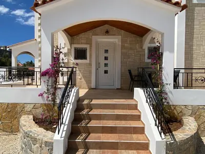 a staircase leading to a house with flowers at Villa Astrea in Sinoikismós Mamounianá