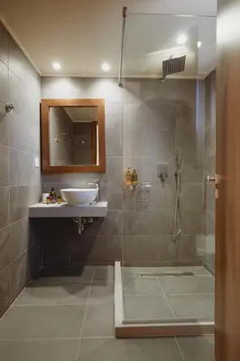 a bathroom with a sink and a shower at Giannoulis Ele Villas in Skoutelónas