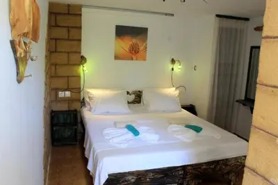 a bedroom with two beds with towels on them at Village Villa Marika Drapanias in Drapaniás