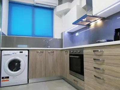 a kitchen with a washing machine and a washer at Dimitrios Cozy Apartment in Chania Town