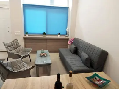a living room with a couch and a table at Dimitrios Cozy Apartment in Chania Town