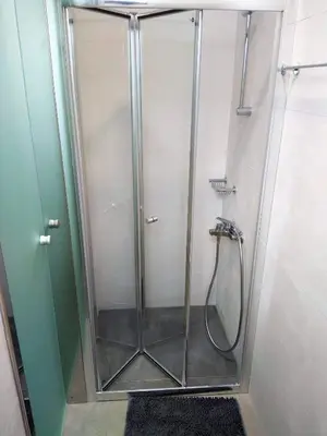a shower with a glass door in a bathroom at Dimitrios Cozy Apartment in Chania Town