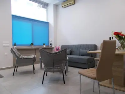 a waiting room with a couch and chairs and a table at Dimitrios Cozy Apartment in Chania Town
