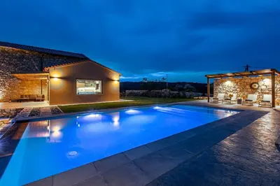 a swimming pool in the backyard of a house at Villa Alargo Heated Pool in Katokhórion