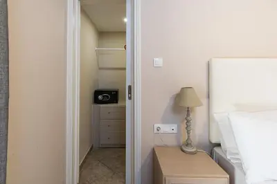 a bedroom with a bed and a lamp on a night stand at Mear Luxury Holiday Homes - Cretan Sunny Gems in Kountoura Selino