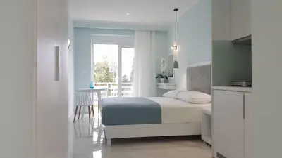 a bedroom with a bed and a table and a window at Mear Luxury Holiday Homes - Cretan Sunny Gems in Kountoura Selino