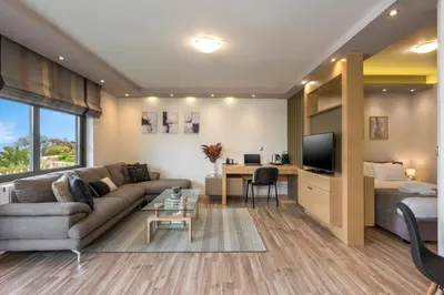 a living room with a couch and a bed at Zen Luxury Studio in Kalamaki Chanion