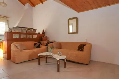 a living room with two couches and a table at Sternes house in Stérnai