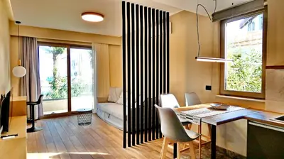 a living room with a table and a couch at GoldenRoyalSuites in Stalos