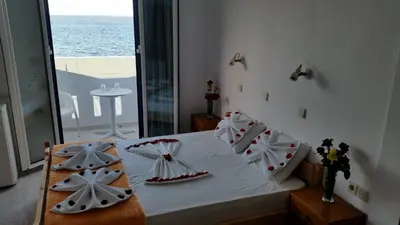 a bedroom with a bed with a view of the ocean at Tarra in Agia Roumeli