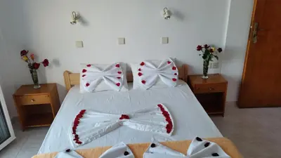 a bedroom with a bed with bow ties on it at Tarra in Agia Roumeli