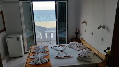 a bedroom with a bed with a view of the ocean at Tarra in Agia Roumeli