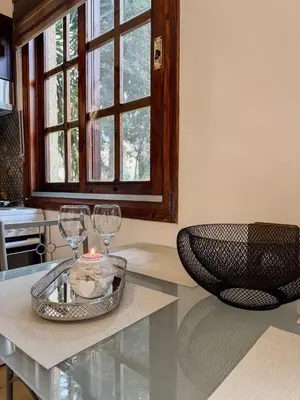 a table with two wine glasses and a candle on it at Mike's appartments in Chania Town