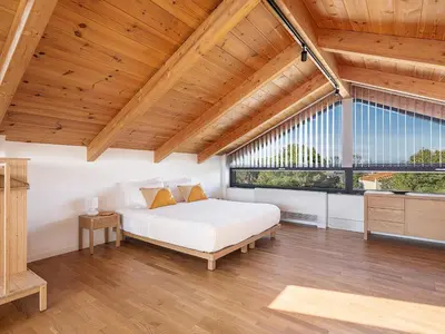 a bedroom with a bed and a large window at Villa Melista in Kounoupidhianá
