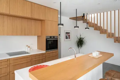 a kitchen with wooden cabinets and a counter top at Villa Melista in Kounoupidhianá