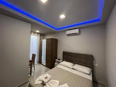 a bedroom with a bed with a blue ceiling at Holiday Base in Stalos