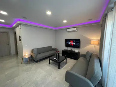 a living room with a couch and a tv at Holiday Base in Stalos