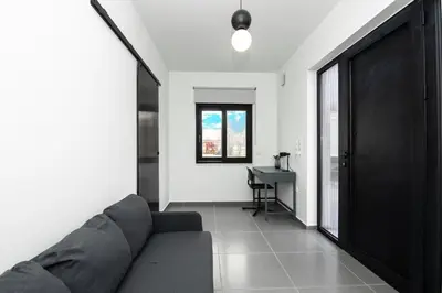 a living room with a couch and a desk at Tolis Exclusive Villa in Kissamos