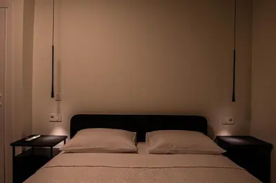 a bed with two pillows and two night stands at Tolis Exclusive Villa in Kissamos