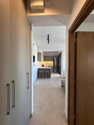 a hallway leading to a kitchen and a living room at Etherio Urban Loft in Chania Town