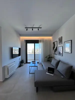 a living room with a couch and a tv at Etherio Urban Loft in Chania Town