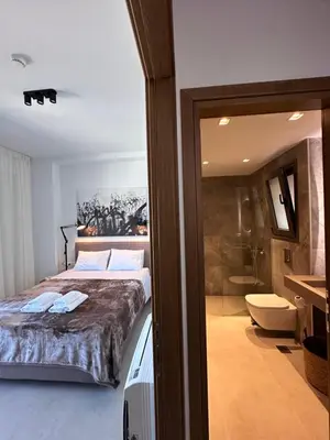 a bedroom with a large bed and a bathroom at Etherio Urban Loft in Chania Town