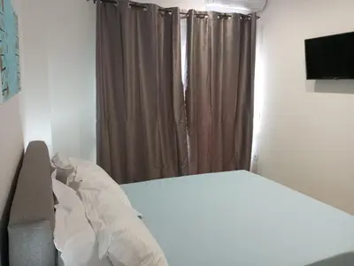 a bedroom with a bed and a couch and a window at Golden Orb in Chania Town