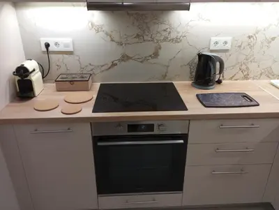 a kitchen with a stove top oven next to a counter at Silver Orb in Chania Town