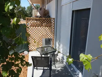 a patio with two chairs and a table on a balcony at Silver Orb in Chania Town