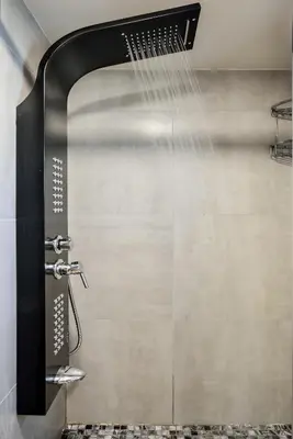 a shower with a shower head in a bathroom at Kumka seafront suite in Chania Town