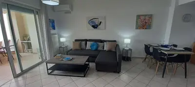 a living room with a couch and a table at Seaside apartment in Chania in Chania Town
