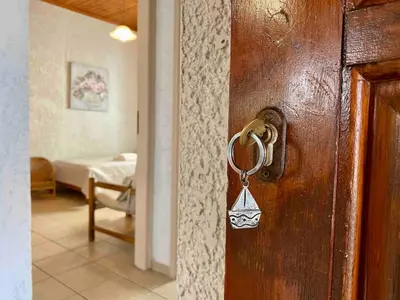 a wooden door with a key in a room at Batilas House next to exotic beach of Elafonisi in Elafonisi