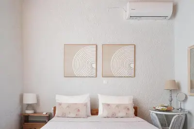a bedroom with two pictures on the wall and a bed at Batilas House next to exotic beach of Elafonisi in Elafonisi