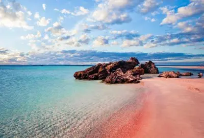 a beach with some rocks in the water at Batilas House next to exotic beach of Elafonisi in Elafonisi