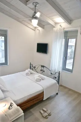 a bedroom with a bed with towels on it at Serena Residence in Chania Town
