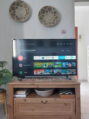 a flat screen tv sitting on top of a wooden stand at Stavros Oak Tree House in Vasilópoulon