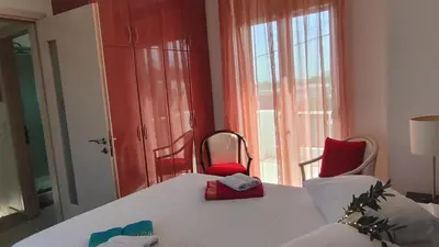 a room with a table and chairs and a window at Villa Anastasia Sissy in Módhion