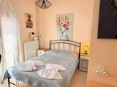 a bedroom with a bed with two plates on it at Little Central Apartment-1min walk from everywhere in Chania Town