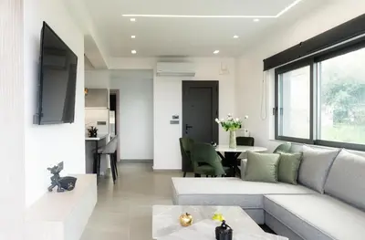 a living room with a couch and a table at Seascape Luxury Apartment 2 in Kounoupidhianá