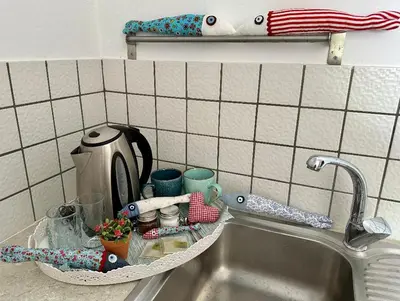 a kitchen sink with a tray next to it at BONATSA Rooms 2 in Palaiochóra