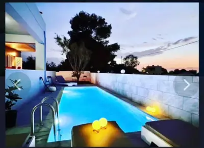 a swimming pool in the backyard of a house at Villa Archontoula in Kambánion
