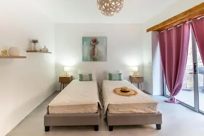 two beds in a room with pink curtains at Casa Ellini unique & spacious by 8essentially in Kókkinos Pírgos
