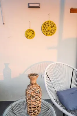 a table with two chairs and a vase on it at Casa Ellini unique & spacious by 8essentially in Kókkinos Pírgos
