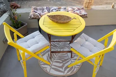 a yellow table with two chairs and a bowl on it at Casa Ellini unique & spacious by 8essentially in Kókkinos Pírgos