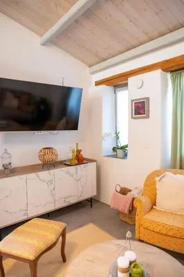 a living room with a tv and a chair at Casa Ellini unique & spacious by 8essentially in Kókkinos Pírgos