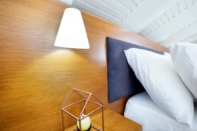 a bedroom with a bed and a lamp at Loft Apartment in Chania Town