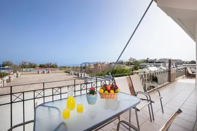 a table on a balcony with fruit and juice at Loft Apartment in Chania Town