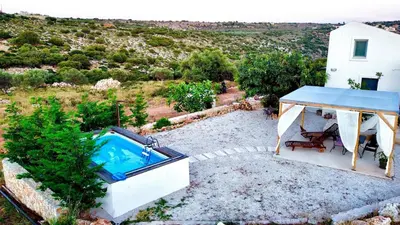 a house with a swimming pool and a gazebo at Villa Voleonas-private pool & olive grove Chania in Kounoupidhianá