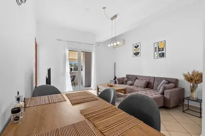 a living room with a table and chairs and a couch at Marika's Apartment in Chania in Chania Town